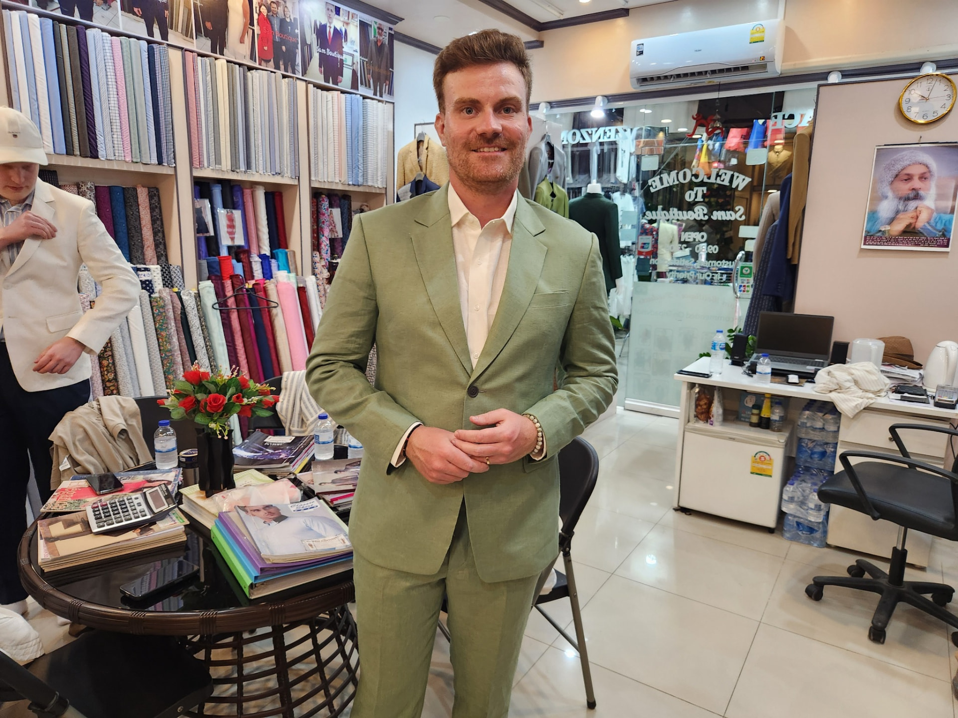 Customer wearing a sage green linen suit tailored in Karon Beach, Phuket