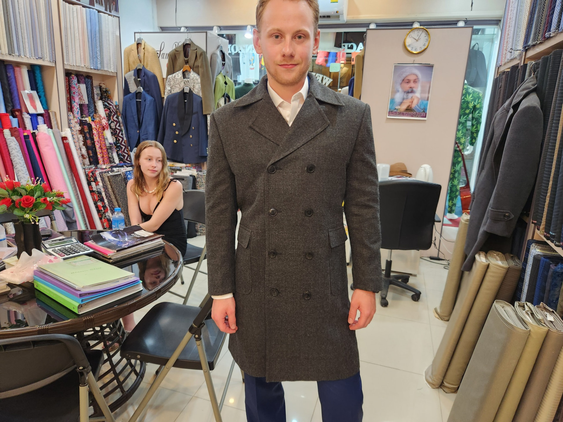 Customer wearing a charcoal double-breasted wool overcoat tailored by Sam Boutique Tailors Phuket