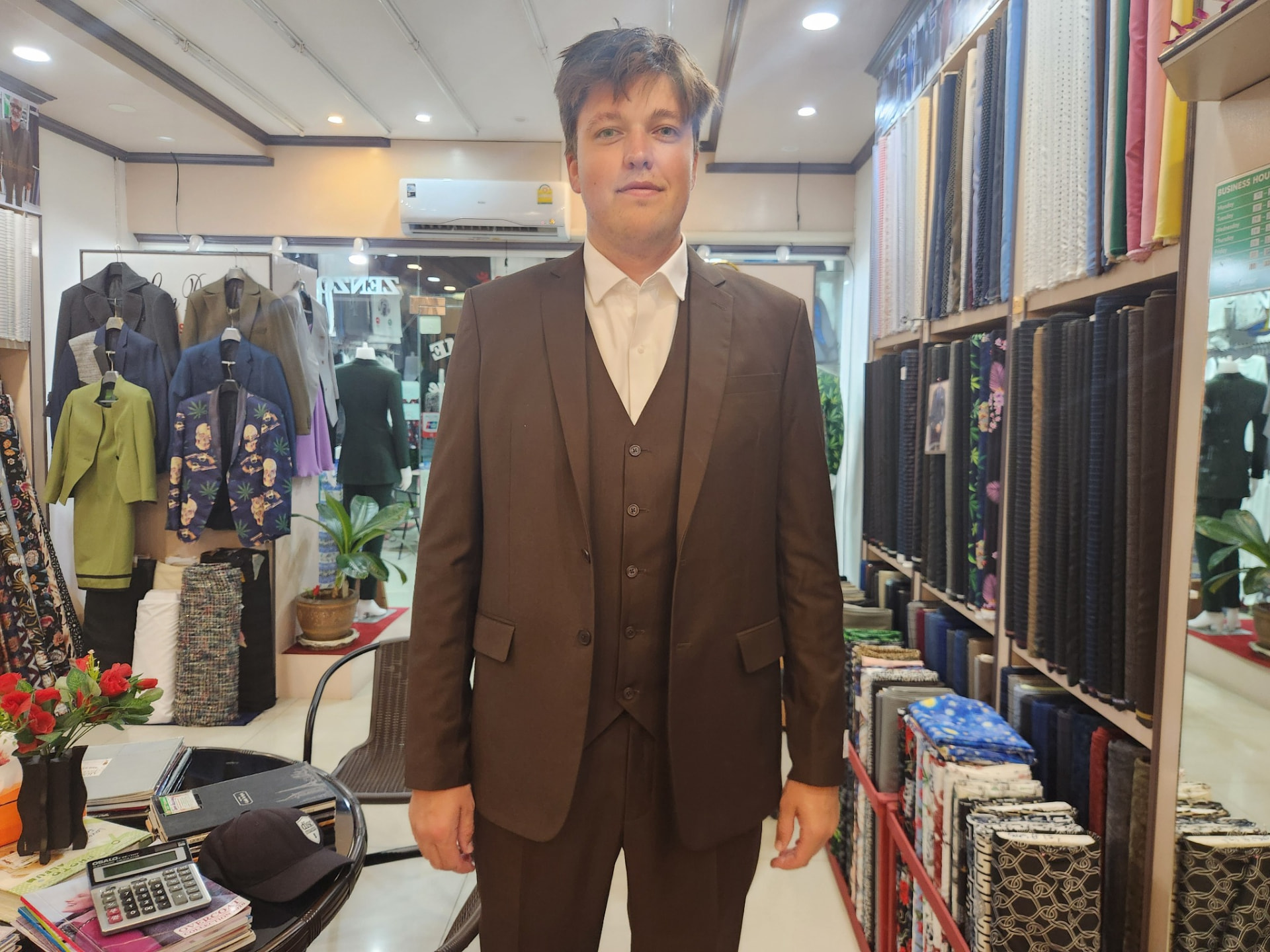 Customer wearing a brown three-piece bespoke suit tailored in Karon Beach, Phuket