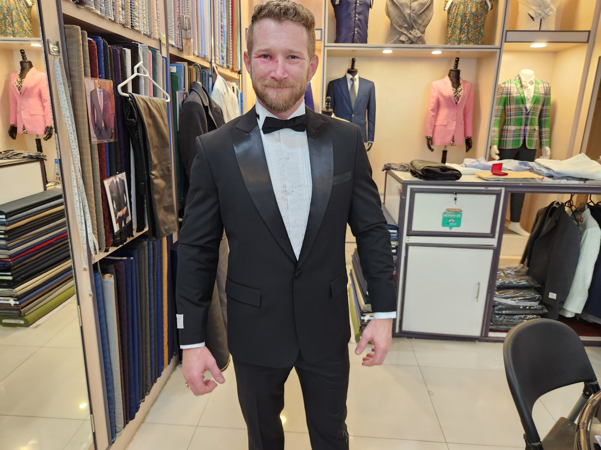 Customer wearing a black bespoke tuxedo with satin lapels made in Karon Beach, Phuket